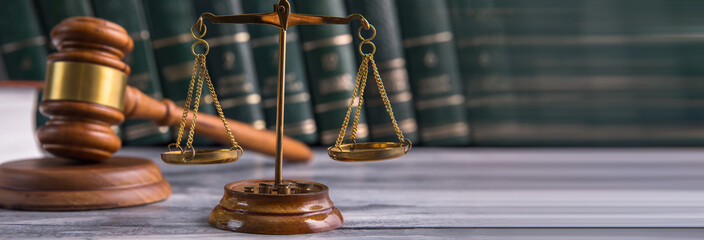Law and Justice Symbols with law books on background.