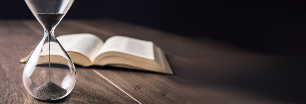 hourgass with book