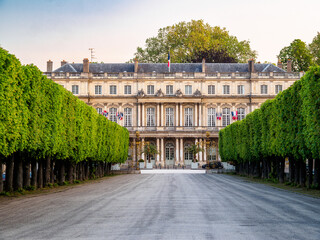 Distant view of the Palais du Gouvernement (Government Palace) with the treelined path at the Place de la Carrière, UNESCO World Heritage SIte, Nancy, Meurthe et Moselle, Lorraine, France. - obrazy, fototapety, plakaty