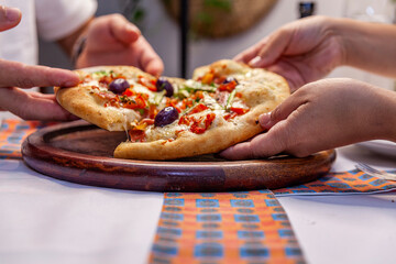 Hands Taking slice of pizza top close up with melted cheese