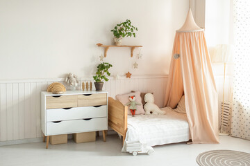 a cozy and bright children's room with a four-poster bed, a chest of drawers, a floor lamp and cute...