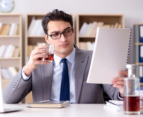 Young businessman drinking from stress