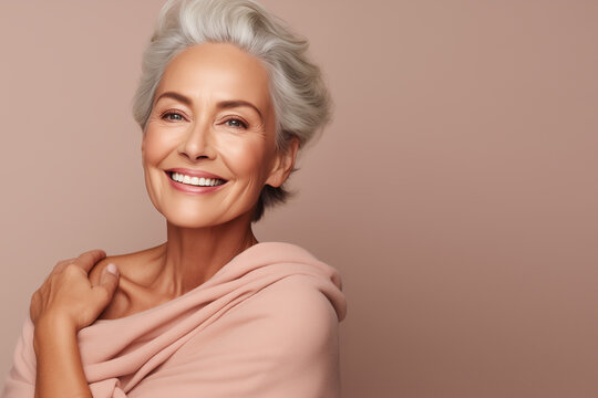 slim pensioner woman positive cosmetology hugs her shoulders smooth skin care self confidence isolated beige color background