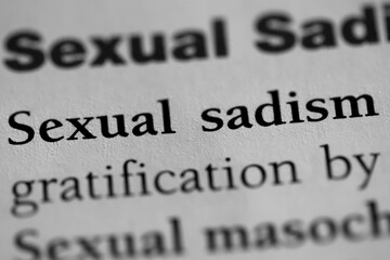 sexual sadist, psychological sexual fetish or obsession terminology printed in black on white paper close-up. medical treatment and therapy. fetish of inflicting pain - obrazy, fototapety, plakaty