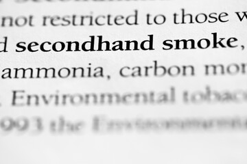 Secondhand smoke, harmful effects of smoking to others in close proximity of smoker, printed in black on white page close-up with selective focus.