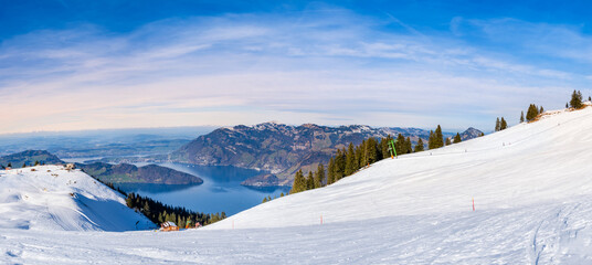 Panorama of Klewenalp mountains and Lake Lucerne or Vierwaldstattersee from mountain peak covered with snow. Popular ski resort in Swiss Alps and winter sport attraction in Switzerland in winter