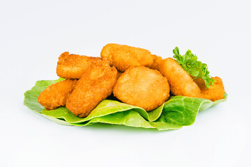 Fast homemade food at home. Breaded chicken nuggets.Breaded Chicken Inner Fillet with green lettuce leaves on a White Background.Chicken Breaded Raw Meat,Fillet.Chicken breaded schnitzels.Fast cooking