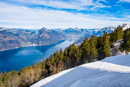 Panorama of Klewenalp mountains and Lake Lucerne or Vierwaldstattersee from mountain peak covered with snow. Popular ski resort in Swiss Alps and winter sport attraction in Switzerland in winter