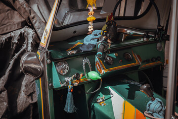 Dashboard and steering wheel and shift lever inside Thai traditional taxi or Three wheels vehicle  (3-wheeler taxi). Tuk-Tuk car interior design. Selective focus.