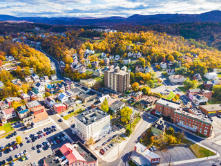 old town of Cumberland in Maryland in the fall. houses, parking lots with cars, and churches among...
