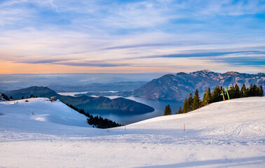 Klewenalp mountain and Lake Lucerne or Vierwaldstattersee at sunset. Mountains covered with snow....
