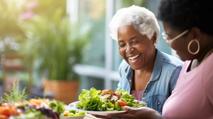 Deurstickers African American Mature woman holding vegan salad with many vegetables. Veganuary, Healthy lifestyle concept. Senior lady Portrait with healthy fresh vegetarian salad.. © Oksana Smyshliaeva