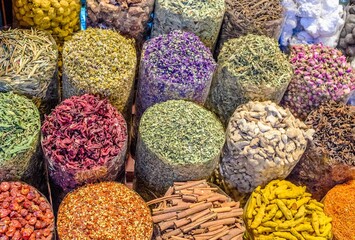 Vibrant and colorful array of different spices and dried flowers are on display at a market