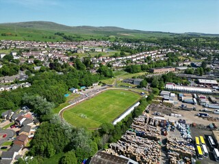 Picturesque rural village in Scotland, with a gleaming football stadium in the foreground
