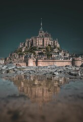 Fototapeta premium Picturesque view of Mont Saint Michel, an island commune in France, from the banks of the river
