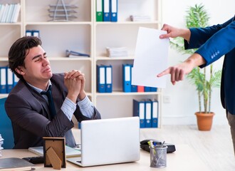 Naklejka premium Young male employee being fired from his work