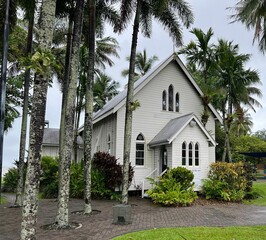 Antique Port Douglas St Mary by the Sea Church, surrounded by lush palm trees