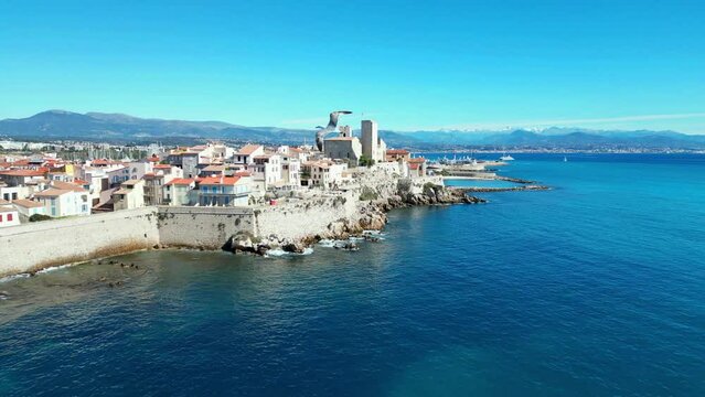Drone view of Antibes town with Chateau Grimaldi castle along sea on a sunny day in France