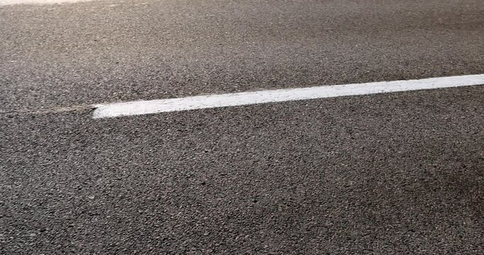 asphalting a new highway with black new asphalt, a close-up of a part of a new paved road