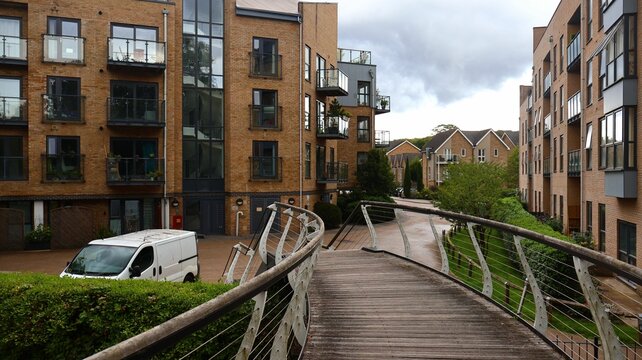 Wooden footbridge with buildings in the background, Apsley, England