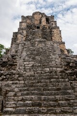 Low angle of ancient Mayan ruins isolated on the background of the cloudy sky