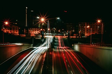 Fototapeta premium Long-exposure of illuminated freeway surrounded by skyscrapers at night