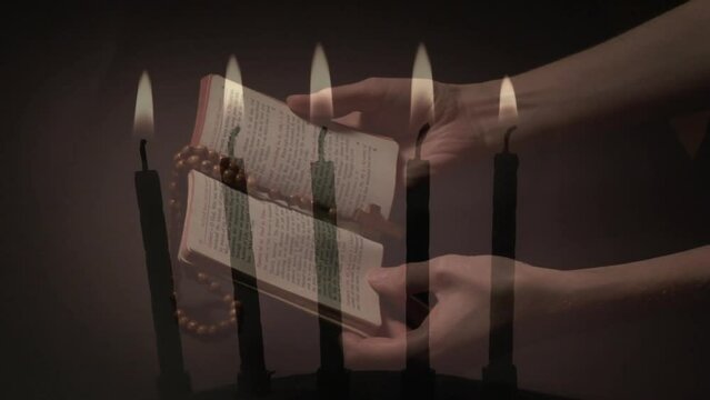 Composite video of burning candles against woman hands holding bible and rosary praying