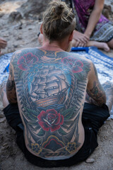 person sitting on the beach tattoo
