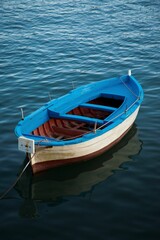 Fototapeta na wymiar Vertical of a wooden boat in a tranquil lake