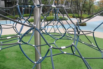 Play area, featuring a climbing net and a turf lawn grass