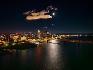 Aerial shot of a full moon over Louisville, Kentucky, and the Ohio River at night.