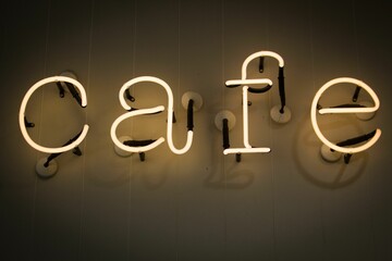 Closeup of a yellow neon sign with the word 