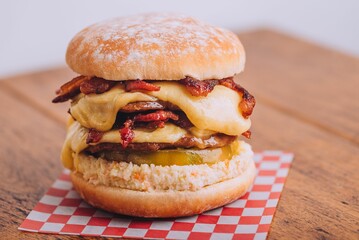 Closeup shot of an appetizing burger with bacon and cheese.