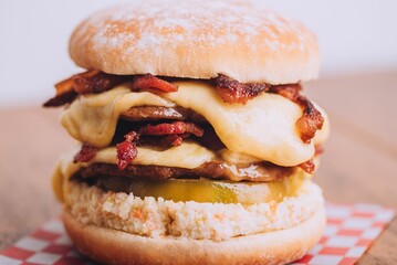 Closeup shot of an appetizing burger with bacon and cheese.