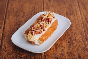 Delicious and juicy hot dog served on a soft and lightly toasted bun on a wooden table.