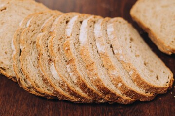Close-up shot of a freshly sliced loaf of bread on a cutting board