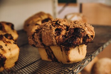 Appealing image of a freshly-baked chocolate muffin resting on a cooling rack