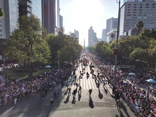 Aerial view of Mexico city paseo de la reforma avenue celebratin a dia de muertos parade on a sunny day, cdmx day of the death parade