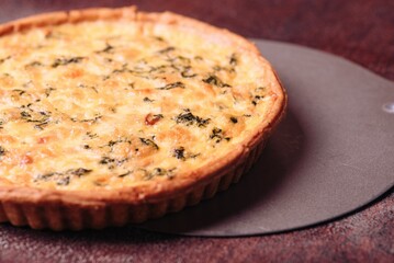 an egg quiche with cheese is on a plate on the table
