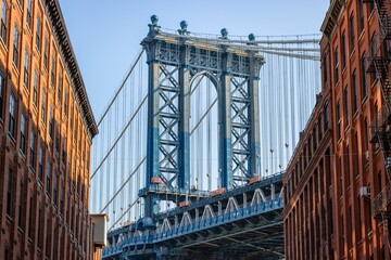 Manhattan Bridge between buildings in the Dumbo neighborhood in Brooklyn, NYC