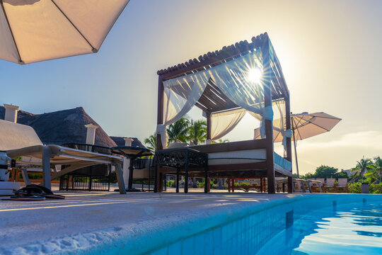 Bed next to an outdoor pool in a resort