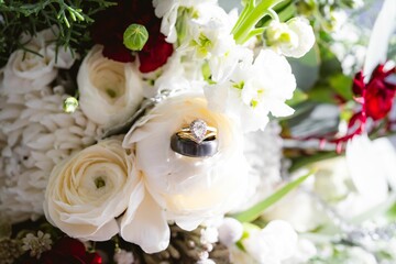 Close-up shot of a Wedding ring in a beautiful rose bouquet