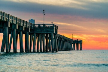 Wooden pier extending into the horizon at dusk in Panama Beach, Florida