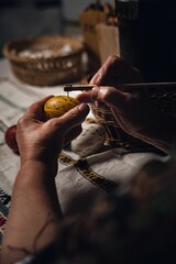 Basket filled with colorful, hand-painted Easter eggs, made using traditional handcrafting technique