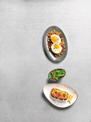 Top view of a various delicious dishes on a gray background