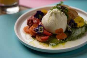 Closeup of burrata cheese with vegetables