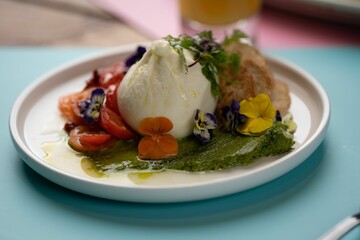 Closeup of burrata cheese with vegetables