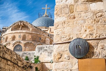 the wall has two large windows, in between three smaller ones with a cross on