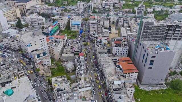 Bustling Streets With Traffic Through Skyline Of Hebron In West Bank Of Palestine. aerial