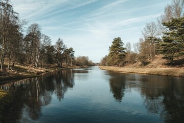 View of a tranquil lake located within a scenic autumn park landscape